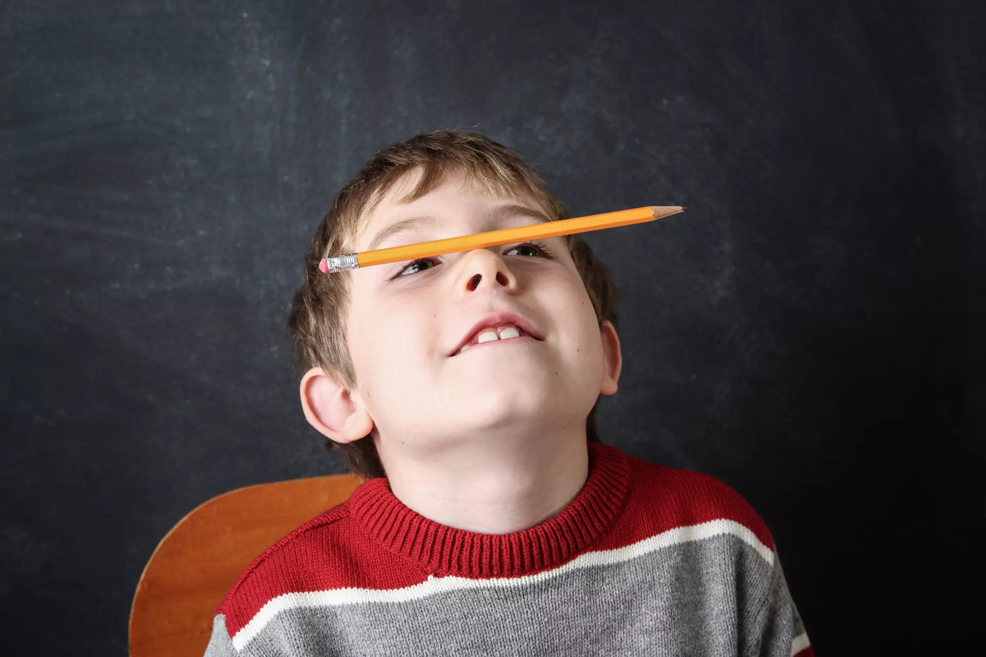 Child with pencil on nose